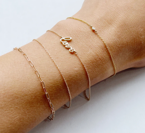 Wrist showcasing permanent bracelets from Love Linked x Winifred Grace